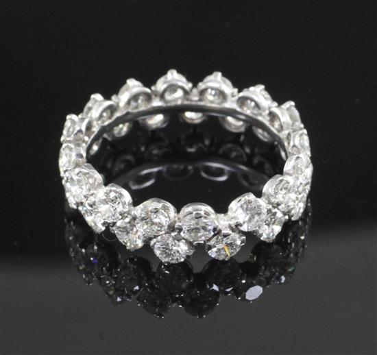 A modern white gold and claw set diamond double row full eternity ring, size P.
